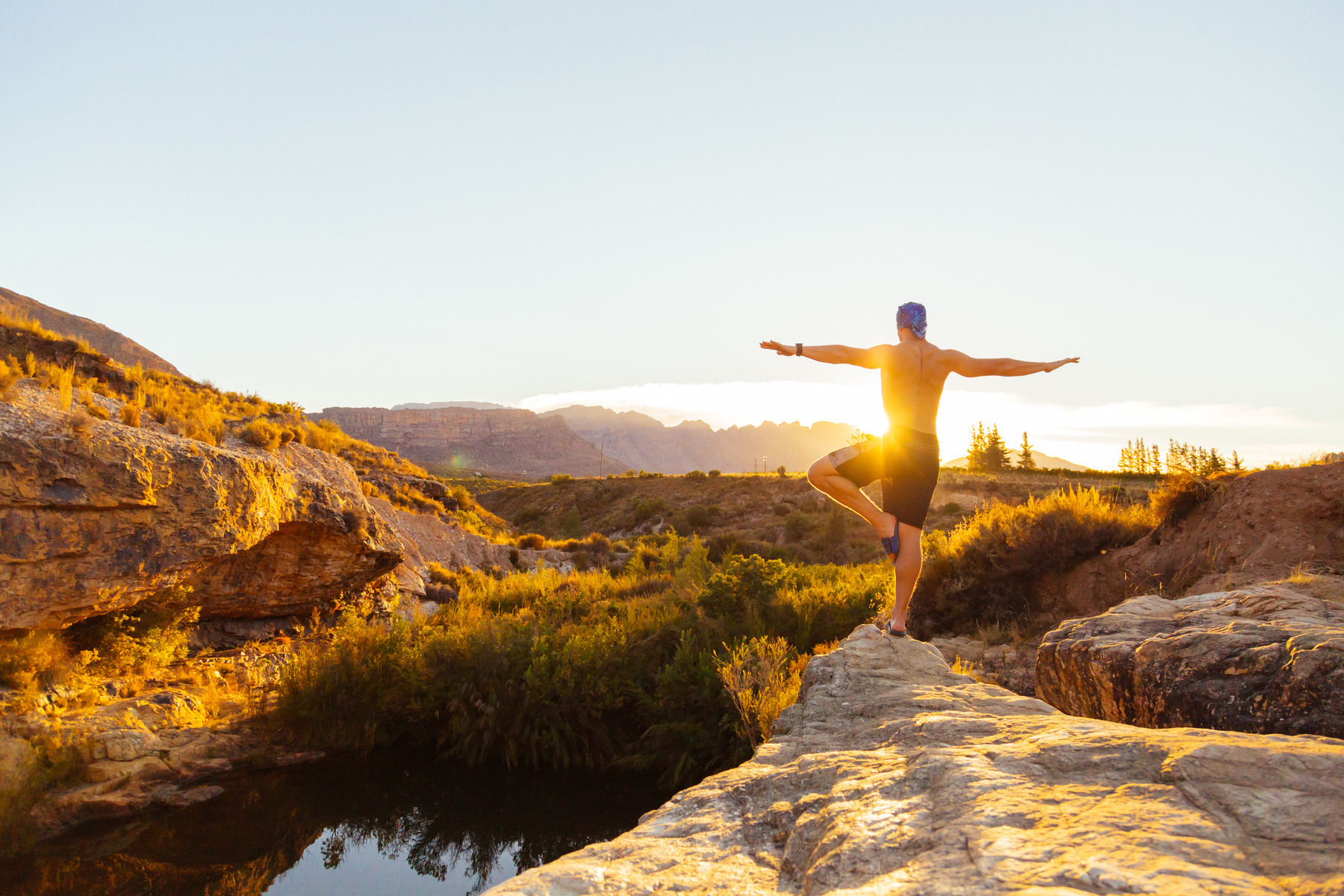 Man Standing on Brown Cliff